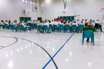 Group of people in chairs watching a magician's performance