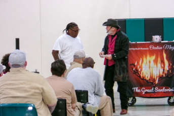 Magician performing with a volunteer