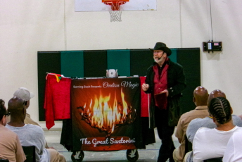 Magician speaking in front of a group of people