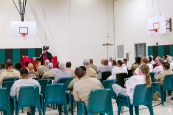 Magician speaking in front of a group of people