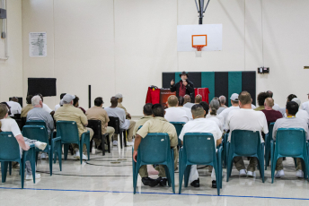 Magician speaking in front of a group of people