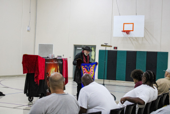 Magician performs in front of a group of people