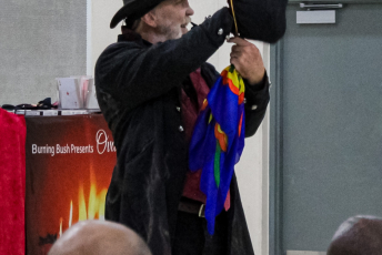Magician performs in front of a group of people