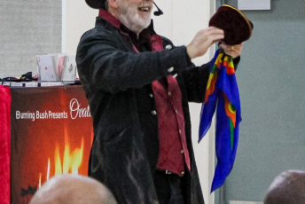 Magician performs in front of a group of people