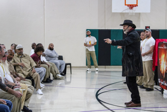 Group of people looking at a magician performing a magic trick