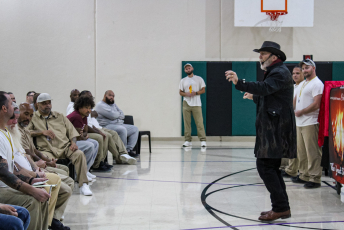 Group of people looking at a magician performing a magic trick